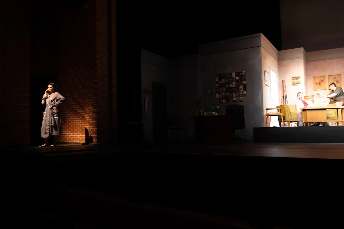 A lone figure in a doorway of the dim office set