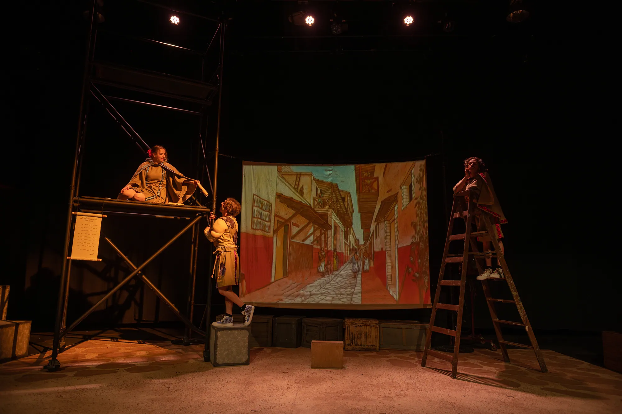 Performers perched across the scaffolding set