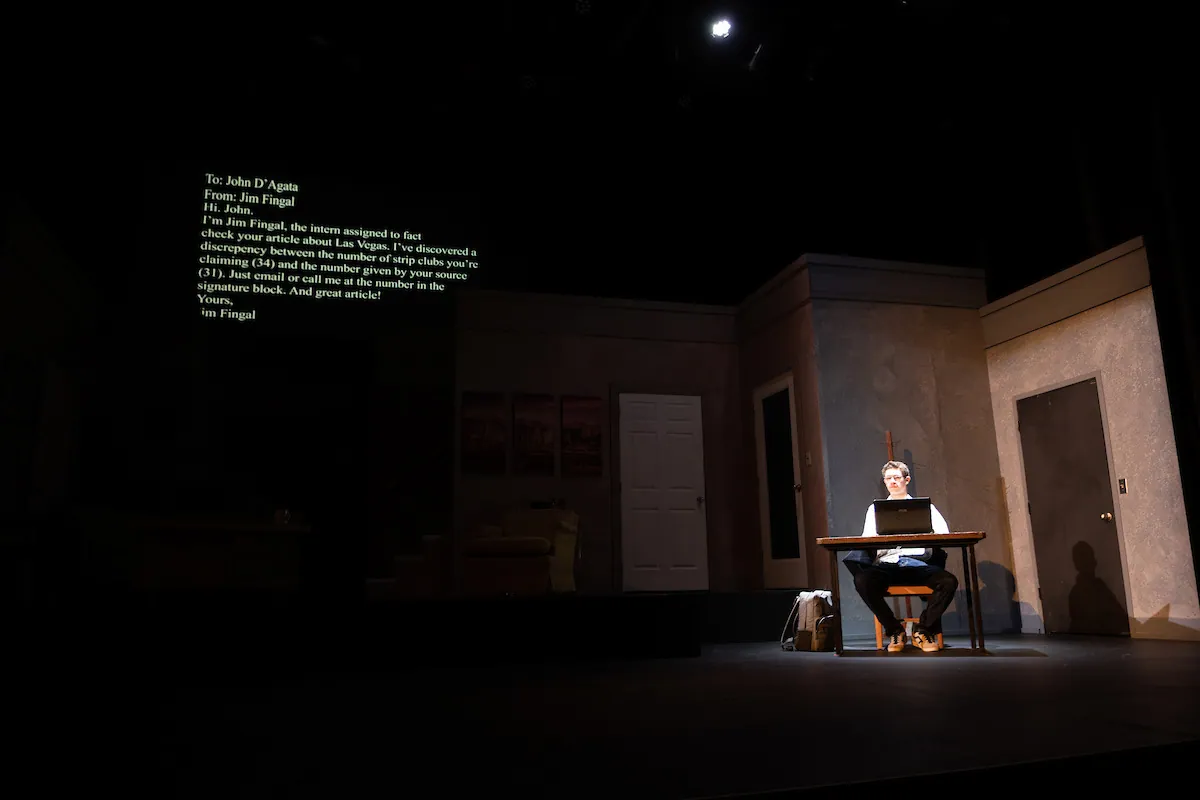 Projected text hangs above a man working at a desk