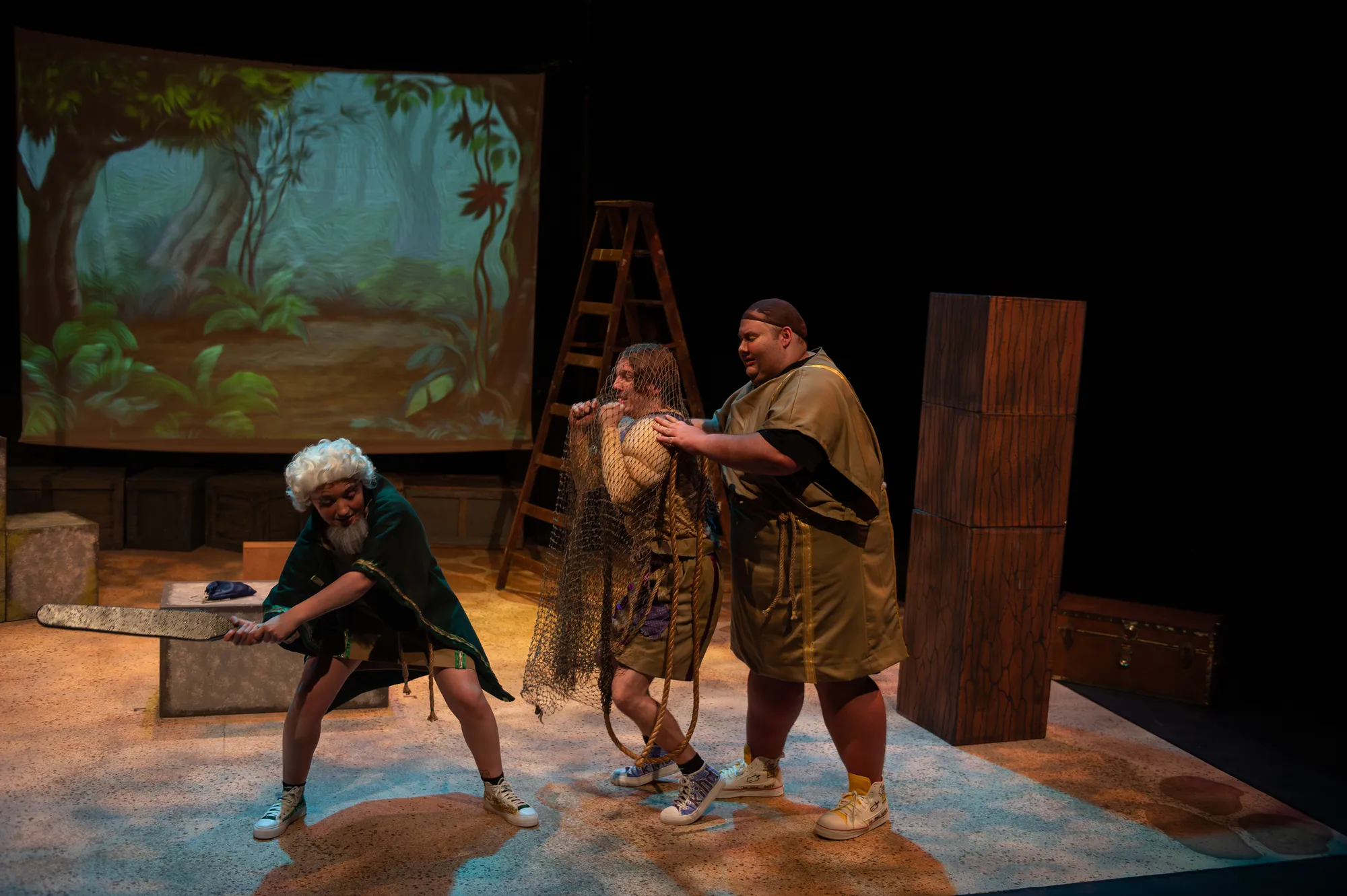 Two actors square off in front of a painted forest backdrop